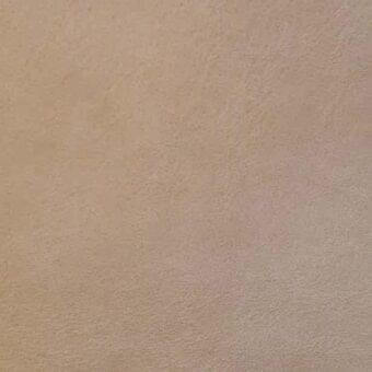 Aniline cashmere leather texture in tortora, displaying a mottled granular surface with consistent organic variation and diffused, even lighting.
